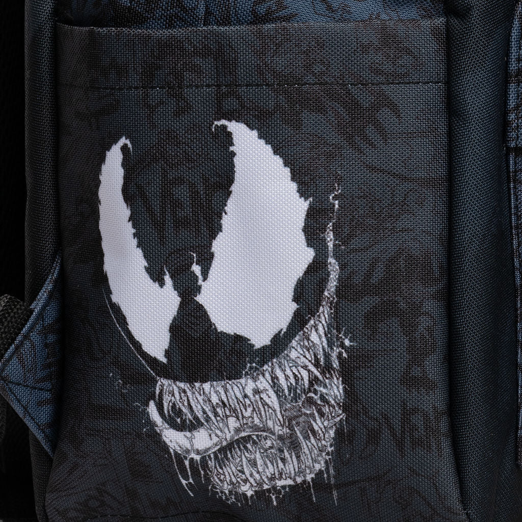 Close-up of a black backpack right side pocket featuring a large white distressed Venom logo, with a subtle dark graphic pattern in the background.
