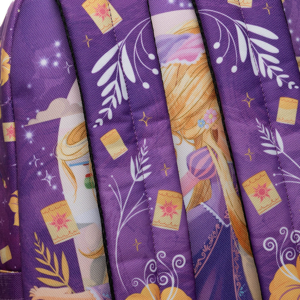 Close-up of WondaPop Disney Rapunzel - Tangled 16" School Backpack's straps printed with a whimsical illustration featuring yellow flowers, white leaf motifs, small yellow lanterns, and star details.