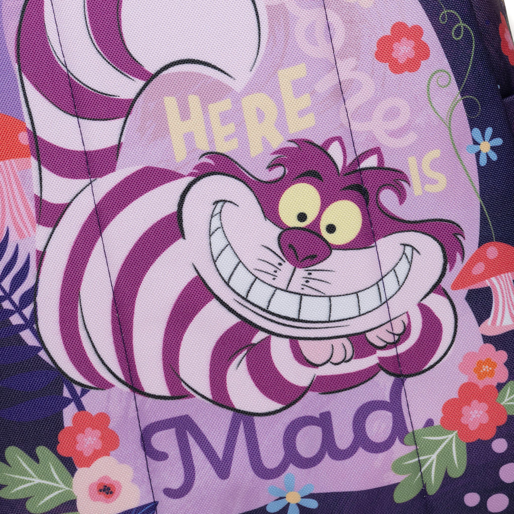 A close-up of a WondaPop Disney Cheshire Cat - Alice in Wonderland 16" School Backpack back fabric surface featuring a Cheshire Cat design with the words 'HERE IS Mad' and floral accents in a whimsical Mad Tea Party style.