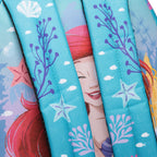 Close-up of the WondaPop Disney Ariel - The Little Mermaid 16" School Backpack straps featuring a mermaid-themed print with turquoise blue background, purple seaweed, and white starfish.