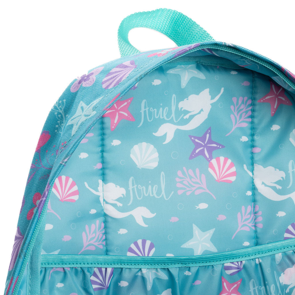A close-up of WondaPop Disney Ariel - The Little Mermaid 16" School Backpack's custom lining featuring a mermaid and sea-themed print. The backpack is light aqua blue with white mermaids, pink and purple starfish, seashells, and the name 'Ariel' printed in script.