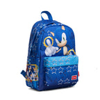 A blue Sonic the Hedgehog backpack featuring a large graphic of Sonic above the front pocket, white star patterns, and a red Sonic logo patch on the bottom left.