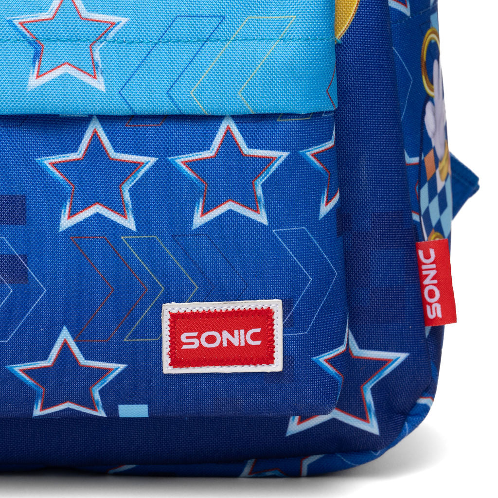 Close-up of a blue patterned backpack with star motifs and a red Sonic logo patch on the front, shown against a white background.