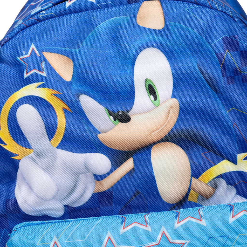 Close-up of a blue backpack featuring Sonic the Hedgehog artwork, with Sonic's face, green eyes, white gloves, and a yellow ring on a patterned blue background.